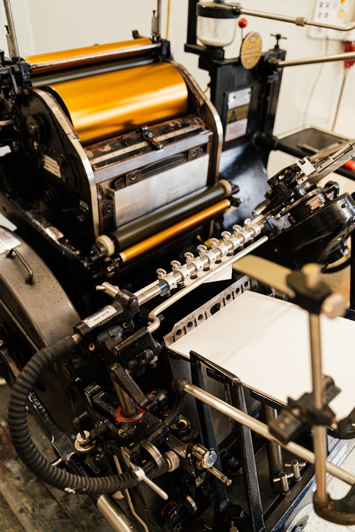 Detailed view of an old-fashioned printing press showing industrial machinery.